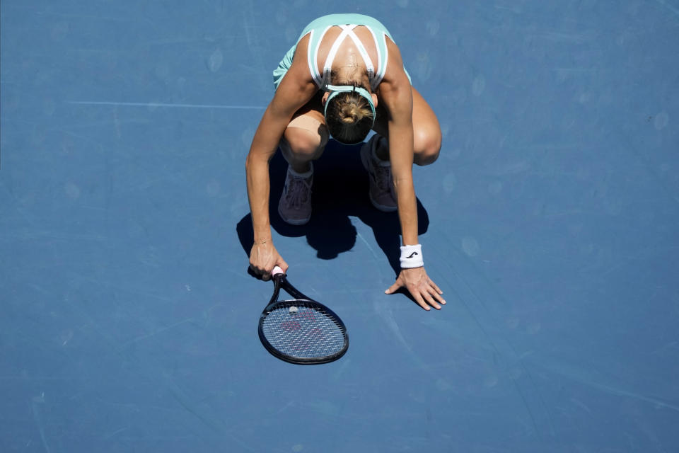 Magda Linette of Poland reacts after losing a point to Caroline Garcia of France during their fourth round match at the Australian Open tennis championship in Melbourne, Australia, Monday, Jan. 23, 2023. (AP Photo/Aaron Favila)