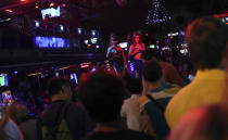 In this March 12, 2014 photo, foreign tourists watch a performance by nightclub dancers in Phuket province, southern Thailand. Thailand’s sapphire blue waters, wildlife parks, delicious cuisine and raunchy red light districts have attracted tourists for decades. Phuket is one of Thailand’s tourism honeypots. Tourists flock here in droves each year for its sun, sand and laid back ambience. And some lose their passports along the way. (AP Photo/Sakchai Lalit)