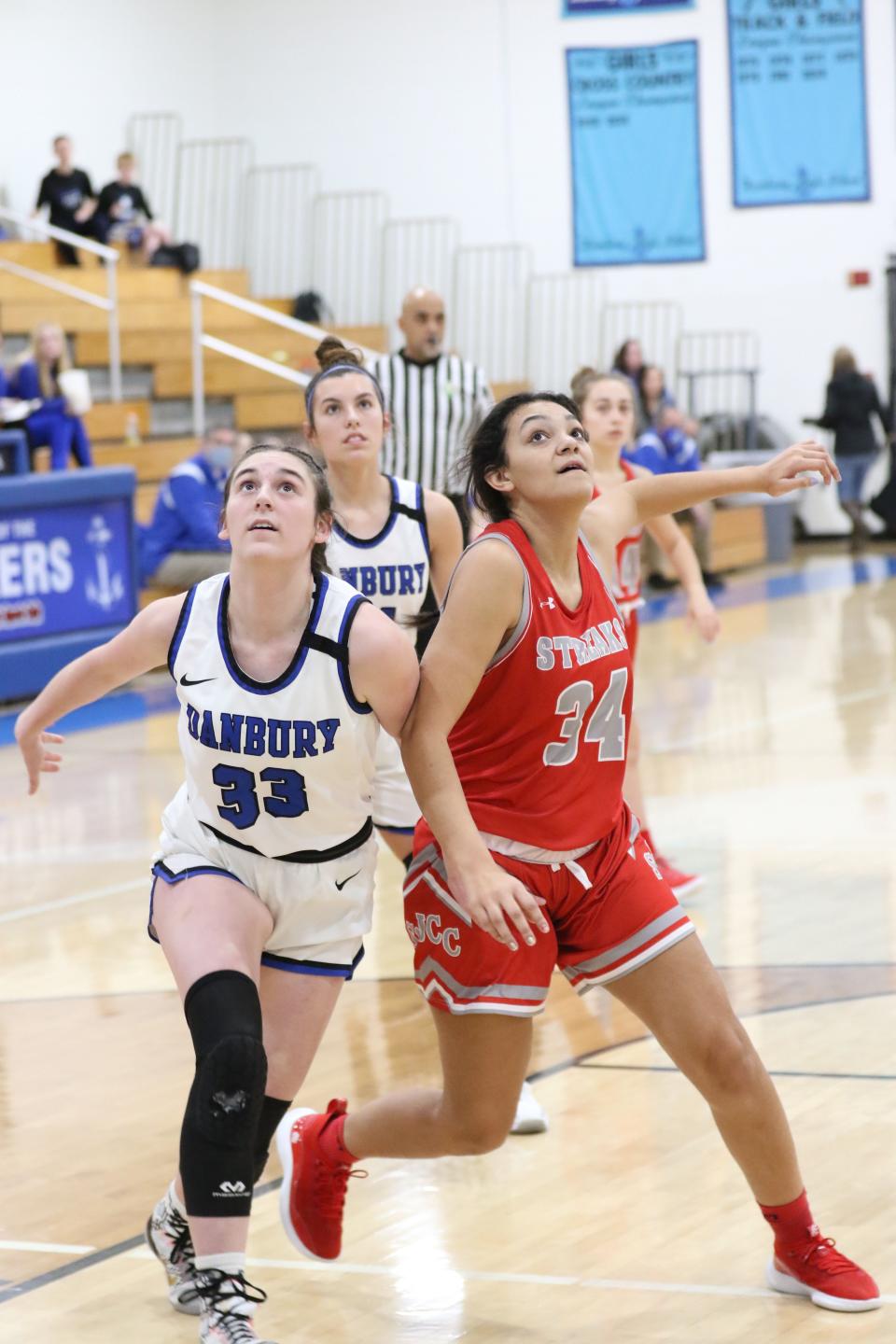 Danbury's Natalie Rose and SJCC's Avey Fleming battle for position.