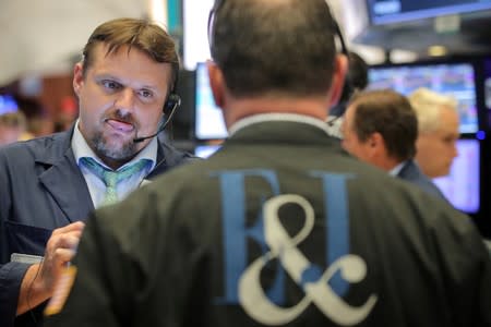 FILE PHOTO: Traders work on the floor at the NYSE in New York