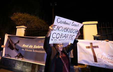 Demonstrators display banners, which read: "Cardinal Ezzati: Coward covering up! They will not steal our hope. Another church is possible" and "Survivors Network of ecclesiastical abuse", during a rally against Archbishop of Santiago Ricardo Ezzati and the sexual abuse in the Chilean Roman Catholic Church outside Ezzati's residence in Santiago, Chile, October 4, 2018. REUTERS/Ivan Alvarado