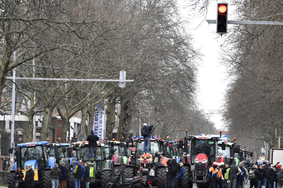 Farmers with their tractors block traffic on a road in the center of Brussels, during a demonstration, Friday, March 3, 2023. Hundreds of tractors driven by angry farmers protesting a plan to cut nitrate levels drove into Belgium's capital city on Friday causing major traffic disruption. (AP Photo/Geert Vanden Wijngaert)