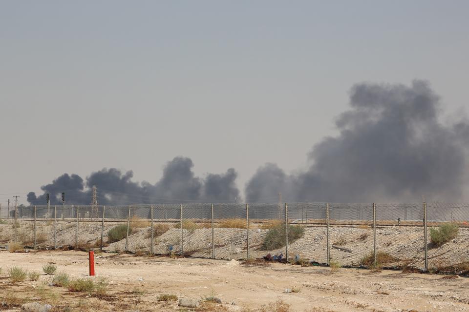 TOPSHOT - Smoke billows from an Aramco oil facility in Abqaiq about 60km (37 miles) southwest of Dhahran in Saudi Arabia's eastern province on September 14, 2019. - Drone attacks sparked fires at two Saudi Aramco oil facilities early today, the interior ministry said, in the latest assault on the state-owned energy giant as it prepares for a much-anticipated stock listing. Yemen's Iran-aligned Huthi rebels claimed the drone attacks, according to the group's Al-Masirah television. (Photo by - / AFP)        (Photo credit should read -/AFP/Getty Images)