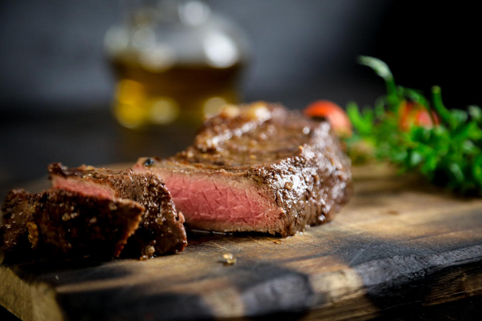 A steak on a cutting board.