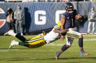 Green Bay Packers' Quay Walker stops Chicago Bears' Justin Fields during the second half of an NFL football game Sunday, Dec. 4, 2022, in Chicago. (AP Photo/Charles Rex Arbogast)