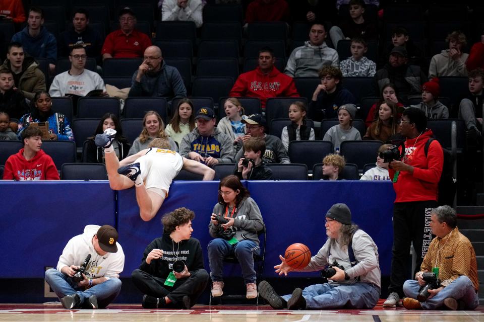 Mar 18, 2023; Dayton, Ohio, United States;  Ottawa-Glandorf's Colin White (22) goes over the divider during the first quarter of the OHSAA Division III boys basketball semifinal game at the University of Dayton Arena. Mandatory Credit: Joseph Scheller-The Columbus Dispatch