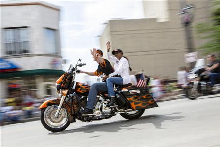 Harley riders wave during the Harley Davidson 110th Anniversary Celebration parade in Wisconsin Avenue, Milwaukee August 31, 2013. REUTERS/Sara Stathas