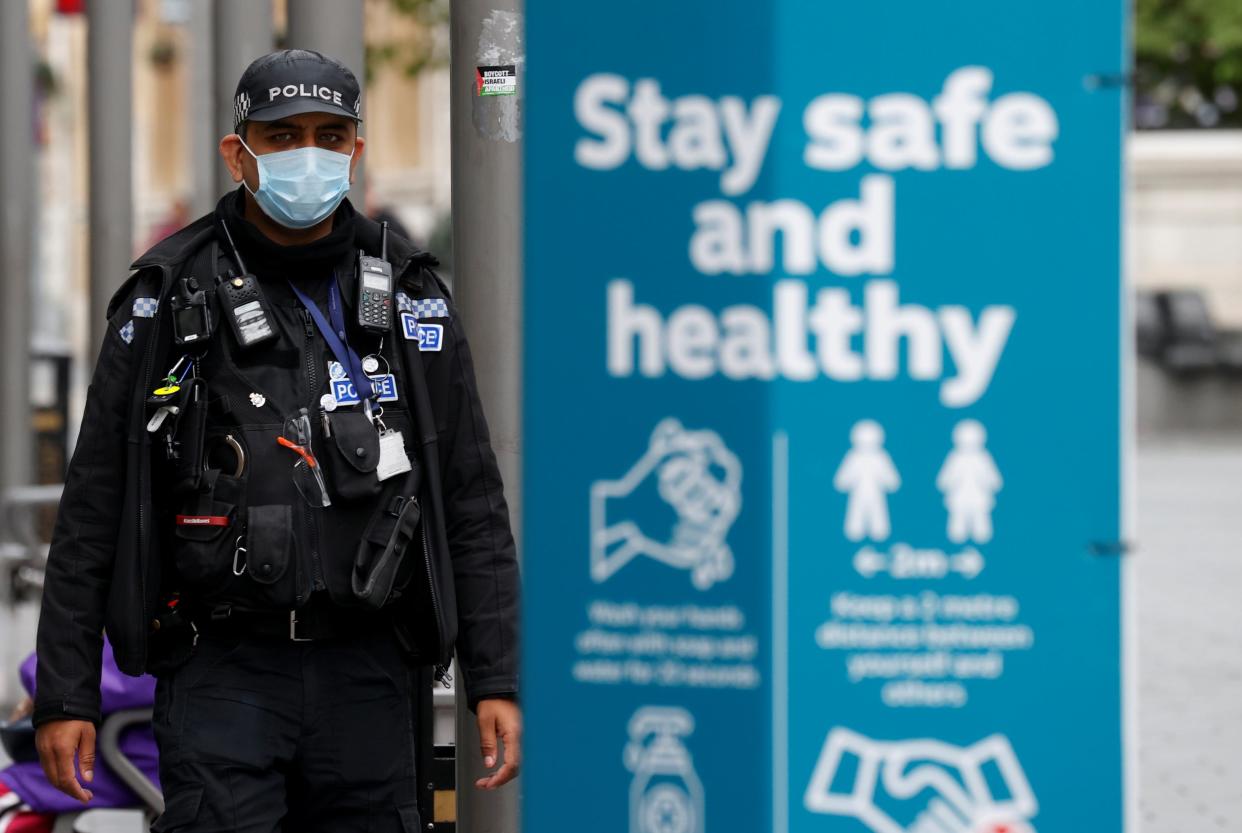 A police officer wearing a protective mask patrols the streets of Leicester following the reintroduction of lockdown: Reuters