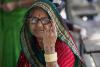 A woman shows her inked finger after casting her vote during the first phase of Gujarat state legislature elections in Limbadi, India, Thursday, Dec. 1, 2022. The voting in Prime Minister Narendra Modi’s home state’s local elections is seen as a barometer of his ruling Bharatiya Janata Party’s popularity ahead of a general election in 2024. (AP Photo/Ajit Solanki)
