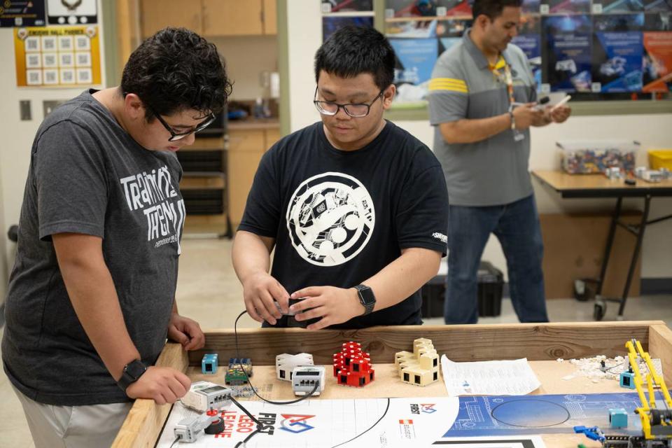 Alex Ortega, left, and Ethan Pajo, right, begin the process of building and programming a robot during a computer science Hackathon at Enochs High School in Modesto, Calif., Saturday, May 11, 2024.