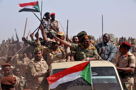 FILE PHOTO: Sudanese President Omar Hassan al-Bashir waves as he leads victory celebrations after the Sudanese Armed Forces (SAF) and the Rapid Support Forces (RSF) defeated the Justice and Equality Movement (JEM) rebels during his visit to the battle area of Gouz Dango in South Darfur April 28, 2015. REUTERS/Stringer/File Photo