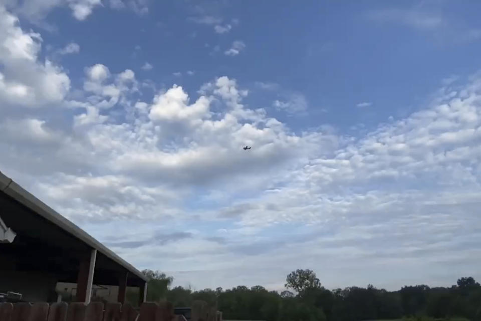 A small airplane circles over Tupelo, Miss., on Saturday, Sept. 3, 2022. Police say the pilot of the small airplane is threatening to crash the aircraft into a Walmart store. The Tupelo Police Department said that the Walmart and a nearby convenience store had been evacuated. (Rachel McWilliams via AP)