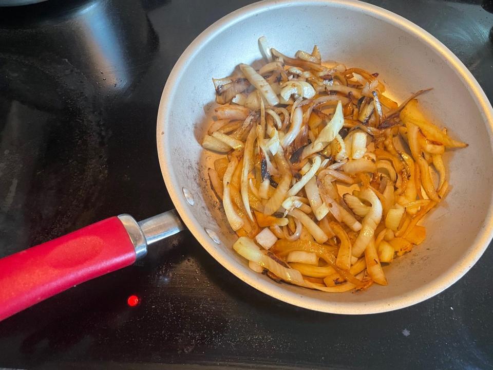 Onions in a pan for Ina Garten's potato gratin