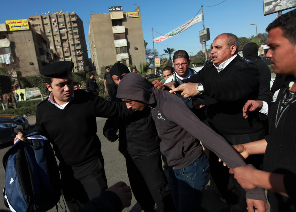 FILE - In this Friday, Jan, 24, 2014 file photo, Egyptian security forces detain one of the supporters for ousted President Mohammed Morsi as they protest in Cairo's Nasr City district, Egypt. On Tuesday, Feb. 11, 2014, the third anniversary of the day Hosni Mubarak stepped down as Egypt’s president after an 18-day uprising, the government blocked access to Tahrir Square and letters emerged from activists reporting that they have been beaten and subjected to other abuses by police after being arrested in a string of protests in late January. (AP Photos/El Shorouk newspaper, Sabry Khaled, File) EGYPT OUT