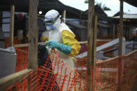 An Ebola health worker is seen at a treatment centre in Beni, Eastern Congo, Tuesday April,16, 2019. Congo's president on Tuesday said he wants to see a deadly Ebola virus outbreak contained in less than three months even as some health experts say it could take twice as long. (AP Photo/Al-hadji Kudra Maliro)