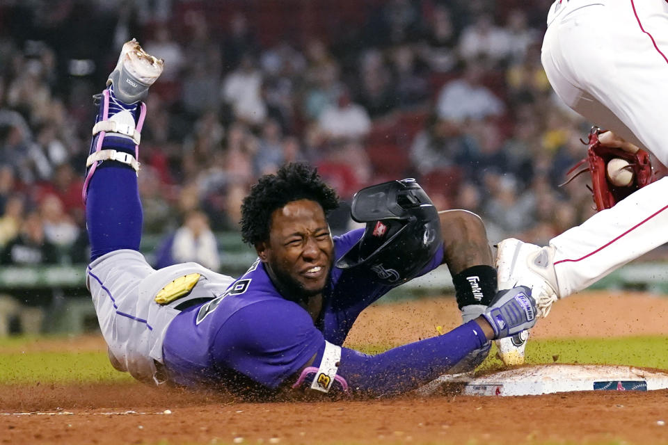 Colorado Rockies' Jurickson Profar is put out by Boston Red Sox relief pitcher Chris Martin, right, while trying to reach first during the ninth inning of a baseball game at Fenway Park, Tuesday, June 13, 2023, in Boston. (AP Photo/Charles Krupa)