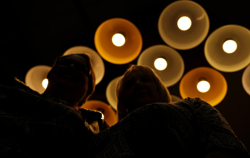 Two women who say a nurse sexually assaulted them while they were unconscious in intensive care are shown inside the offices of their attorneys, Tuesday, Dec. 20, 2022, in Denver. The Associated Press generally does not identify people who say they have been sexually assaulted. (AP Photo/David Zalubowski)