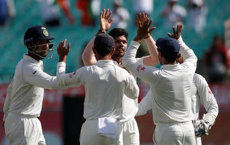 Cricket - India v Australia - Fourth Test cricket match - Himachal Pradesh Cricket Association Stadium, Dharamsala, India - 25/03/17 - India's Umesh Yadav (C-facing camera) celebrates with his teammates after dismissing Australia's Matt Renshaw. REUTERS/Adnan Abidi