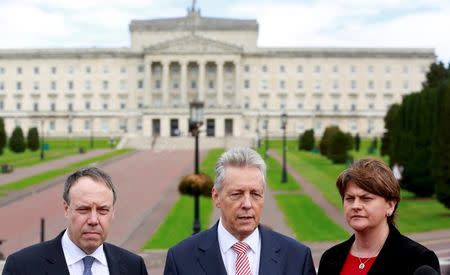 Democratic Unionist Party (DUP) leader Peter Robinson (C) is flanked by party colleagues as he speaks during a news conference in front of Parliament buildings in Stormont, Northern Ireland September 21, 2015. REUTERS/Cathal McNaughton