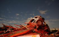 RNPS - PICTURES OF THE YEAR 2013 - A vehicle sits on a pile of debris from the destruction caused by a tornado that touched down in Washington, Illinois, November 17, 2013. A fast-moving storm system triggered multiple tornadoes, killing at least five people, injuring about 40 and flattening large parts of the city of Washington, Illinois as it tore across the Midwest, officials said. REUTERS/Jim Young (UNITED STATES - Tags: DISASTER ENVIRONMENT TPX)