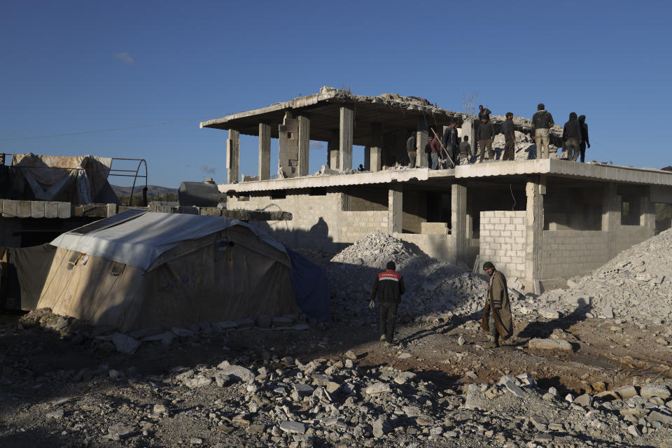 People work on a house damaged in the February 2023 earthquake Jinderis, Syria, on Jan. 27, 2024. (AP Photo/Omar Albam)
