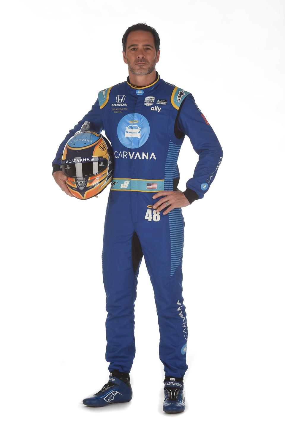 Jimmie Johnson poses in his firesuit ahead of the 2021 IndyCar season.