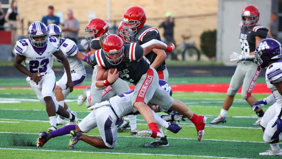 Bedford's Trey Brueggemann bust through the line for a nice gain during a 30-6 win over Ann Arbor Pioneer Friday night.