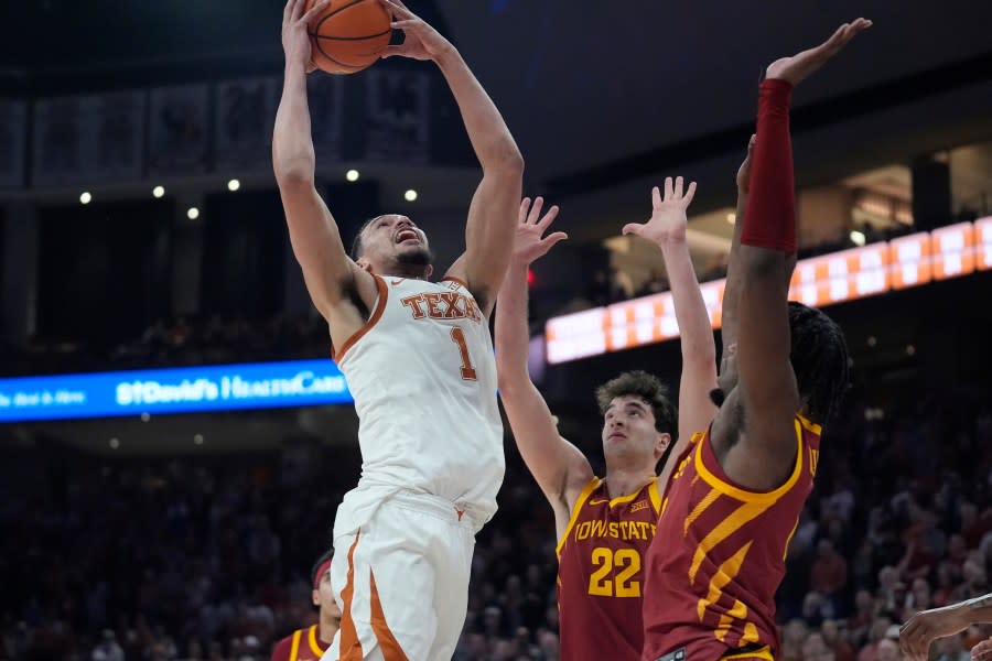 Texas forward Dylan Disu (1) drives to the basket against Iowa State forward Milan Momcilovic (22) and forward Tre King, right, during the second half of an NCAA college basketball game in Austin, Texas, Tuesday, Feb. 6, 2024. (AP Photo/Eric Gay)