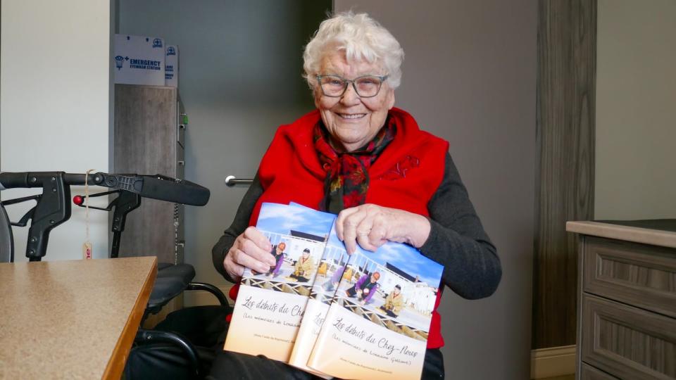 Lorraine Gallant with copies of her new book, Les débuts du Chez-Nous. 