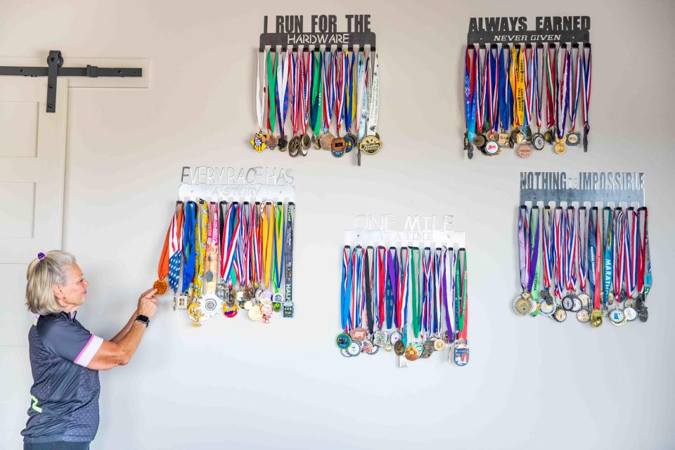 Medals from many different runs are hung up at Anita Rockett’s home on Wednesday, April 27, 2022. Since Rockett’s boating accident that almost resulted in an amputated right leg, Rockett has run races all around the country. 