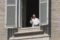 Pope Francis delivers his blessing from the window of his studio overlooking an empty St. Peter's Square, due to anti-coronavirus lockdown measures, at the Vatican, Sunday, April 26, 2020. (AP Photo/Andrew Medichini)