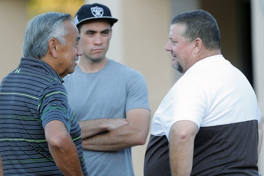 Norm Chow, the former offensive coordinator for USC and UCLA, talks with St. Francis' head coach Jim Bonds before the start of the season home opener non-league football game at St. Francis on Friedman Field on Friday, August 30, 2019.