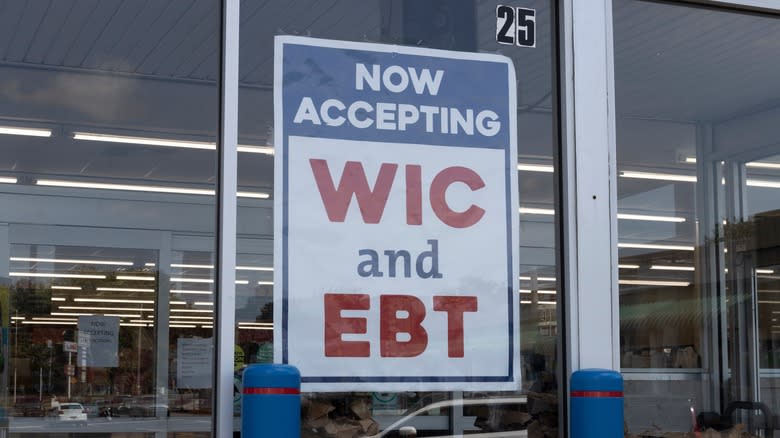 WIC and EBT signs in a grocery store window