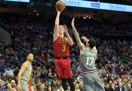 Jan 11, 2019; Philadelphia, PA, USA; Atlanta Hawks guard Kevin Huerter (3) shoots past Philadelphia 76ers guard JJ Redick (17) during the first quarter at Wells Fargo Center. Mandatory Credit: Bill Streicher-USA TODAY Sports