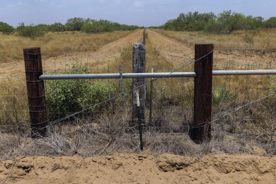 The location of a missing water station for immigrants containing sealed jugs of fresh water sits along a new portion of fence along private property in rural Jim Hogg County, Texas, Tuesday, July 25, 2023. The South Texas Human Rights Center maintains over 100 blue barrels consistently stocked with water across rural South Texas to serve as a life-saving measure for immigrants who have crossed into the United States to travel north in the sweltering heat. (AP Photo/Michael Gonzalez)