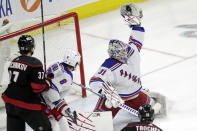 New York Rangers goaltender Igor Shesterkin (31) snags the puck as Rangers defenseman Jacob Trouba (8) and Carolina Hurricanes right wing Andrei Svechnikov (37) look on during the second period during Game 2 of an NHL hockey Stanley Cup second-round playoff series Friday, May 20, 2022, in Raleigh, N.C. (AP Photo/Chris Seward)