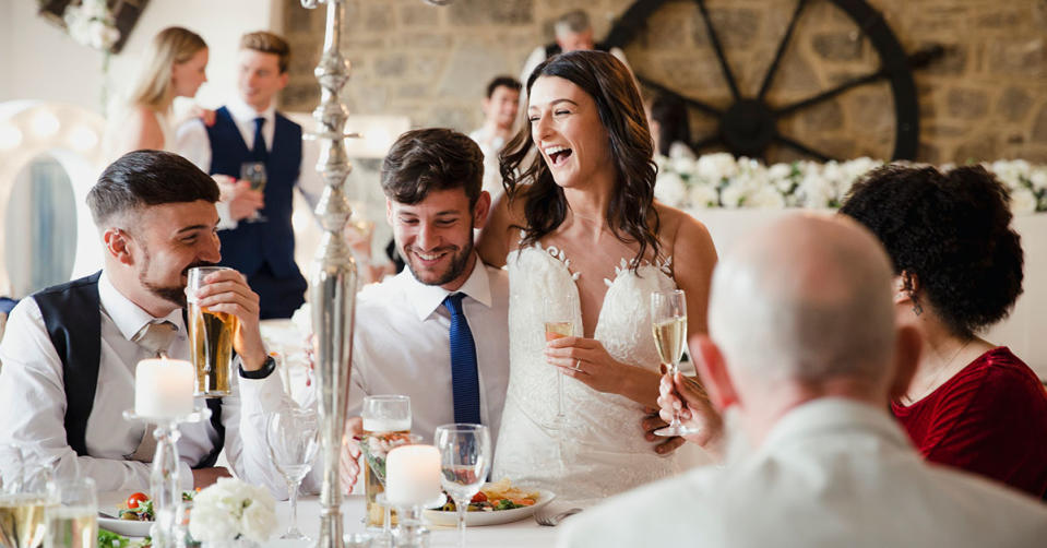 Bride and groom at a wedding reception all drinking alcohol