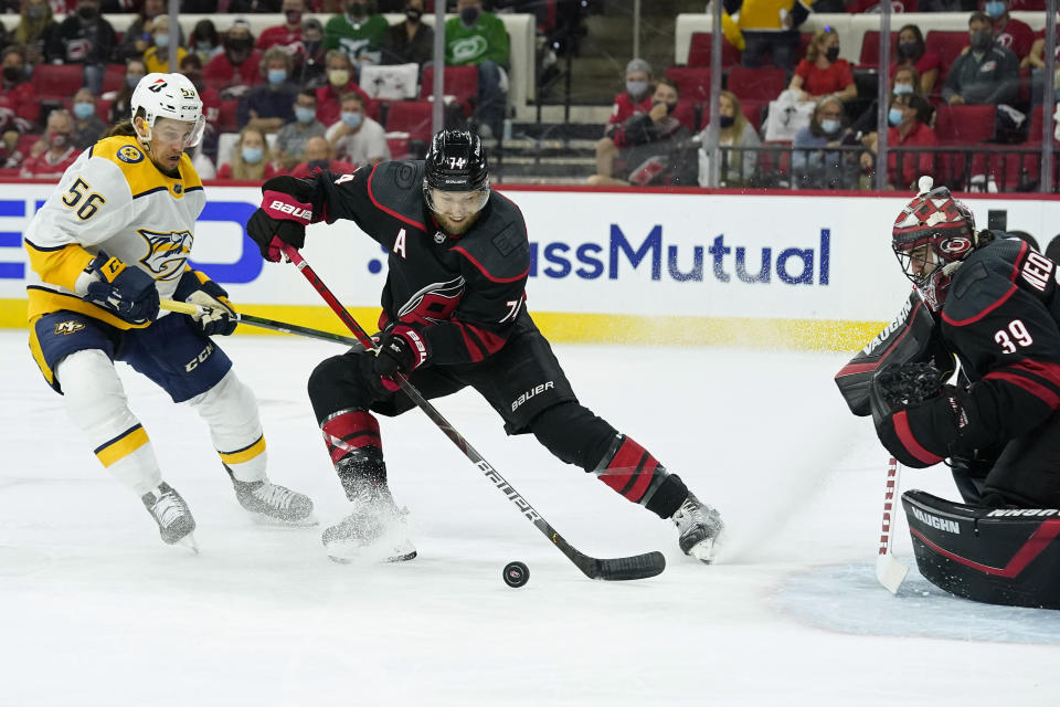 Carolina Hurricanes defenseman Jaccob Slavin (74) and goaltender Alex Nedeljkovic (39) defend the goal against Nashville Predators left wing Erik Haula (56) during the first period in Game 5 of an NHL hockey Stanley Cup first-round playoff series in Raleigh, N.C., Tuesday, May 25, 2021. (AP Photo/Gerry Broome)