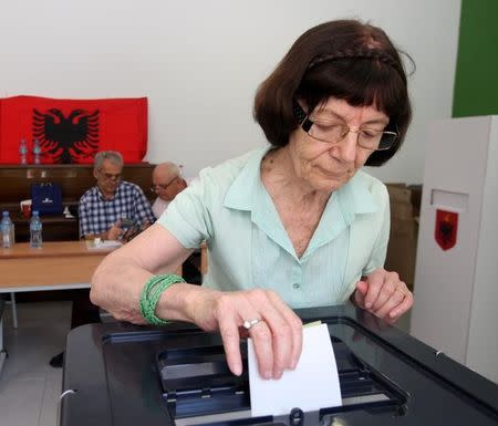 A woman casts her vote during the parliamentary elections in Tirana, Albania June 25, 2017. REUTERS/Florion Goga
