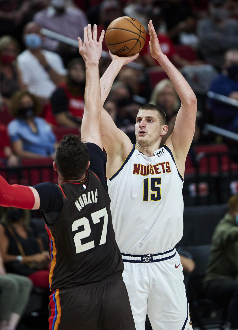 Denver Nuggets center Nikola Jokic shoots over Portland Trail Blazers center Jusuf Nurkic during the first half of Game 6 of an NBA basketball first-round playoff series Thursday, June 3, 2021, in Portland, Ore. (AP Photo/Craig Mitchelldyer)
