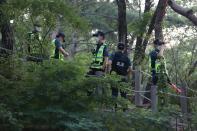 South Korean policemen conduct a search operation for Seoul Mayor Park Won-soon in Seoul