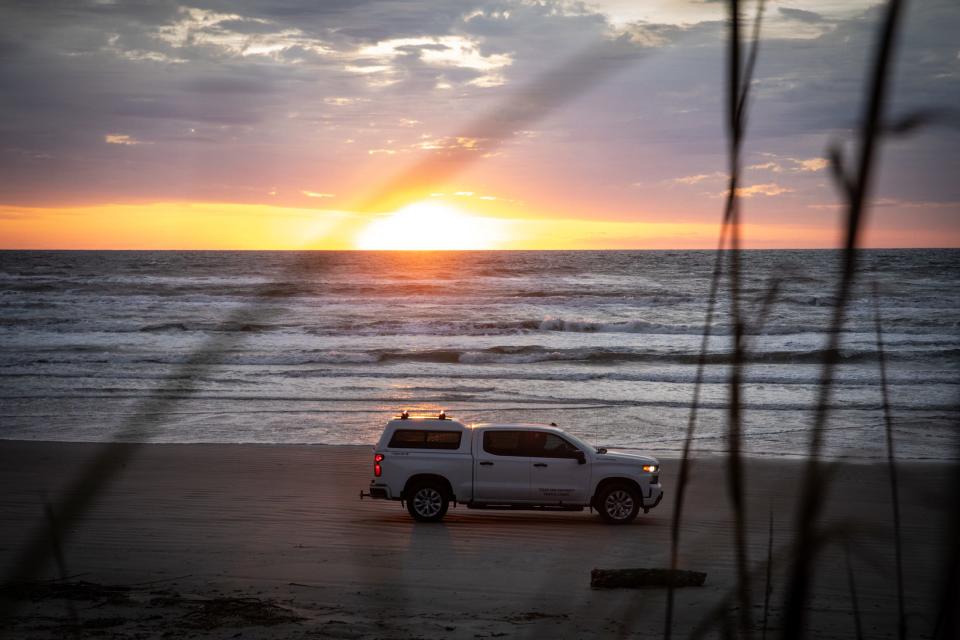 Jace Tunnell drives a university truck along the beach searching for items and animals to create a video on for his beach combing series with Texas A&M — Corpus Christi on Tuesday, March 19, 2024, in Corpus Christi, Texas.