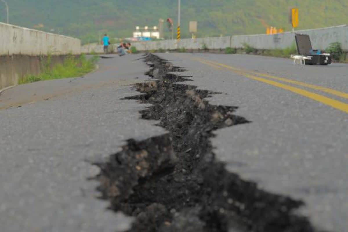 File: A fissure is seen along a road by the collapsed Kaoliao bridge in eastern Taiwan’s Hualien county on 19 September 2022, following a 6.9 magnitude earthquake on 18 September (AFP via Getty Images)