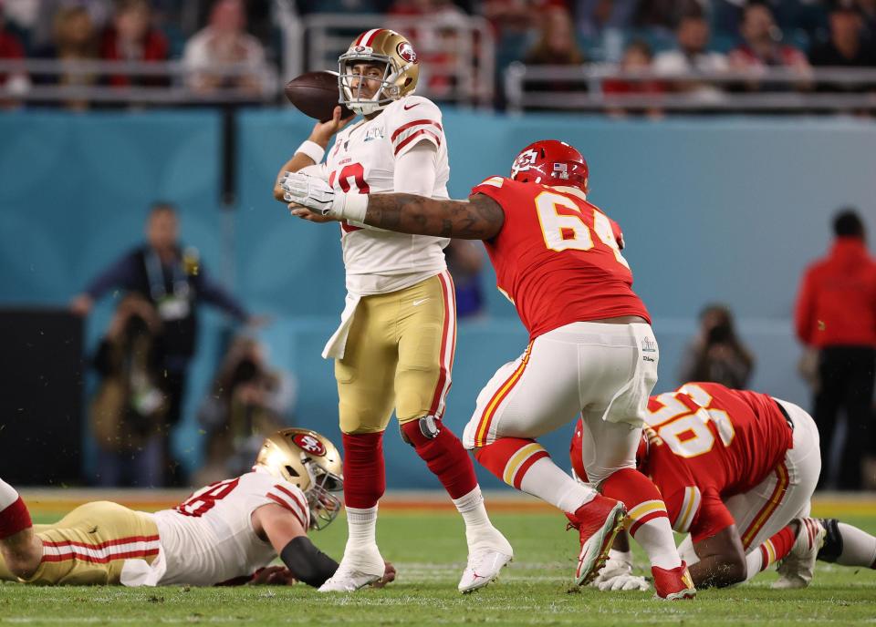 San Francisco 49ers quarterback Jimmy Garoppolo (10) gets pressured by Kansas City Chiefs defensive tackles Chris Jones (95) and Mike Pennel (64) during Super Bowl LIV on Feb. 2 at Hard Rock Stadium in Miami Gardens, Florida.