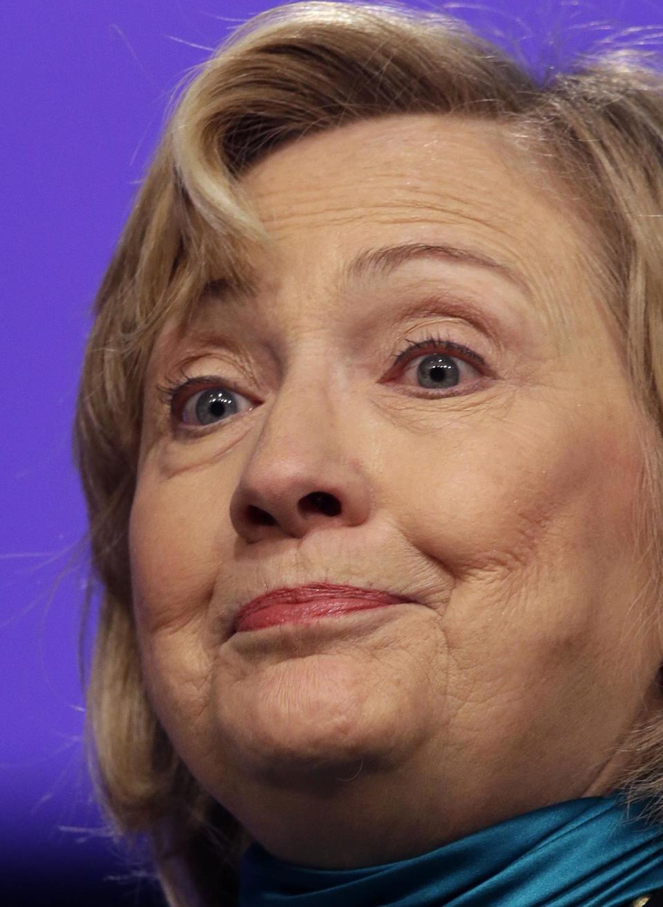 Former Secretary of State Hillary Rodham Clinton pauses while speaking to the National Automobile Dealers Association meeting in New Orleans, Monday, Jan. 27, 2014. (AP Photo/Gerald Herbert)