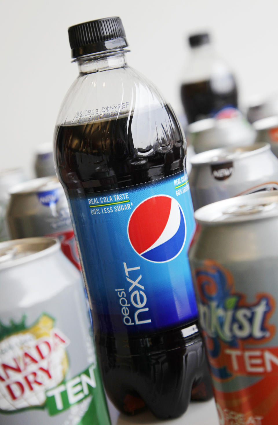 A Monday, June 11, 2012, photo shows a bottle of Pepsi Next displayed amongst cans of ten calorie sodas from PepsiCo Inc. in New York. Coke and Pepsi are chasing after the sweet spot: a soda with no calories, no artificial sweeteners and no funny aftertaste. The world's top soft drink companies hope that's the elusive trifecta that will silence health concerns about soda and reverse the decline in consumption of carbonated drinks. But coming up with such a formula could still be years away. (AP Photo/Mark Lennihan)