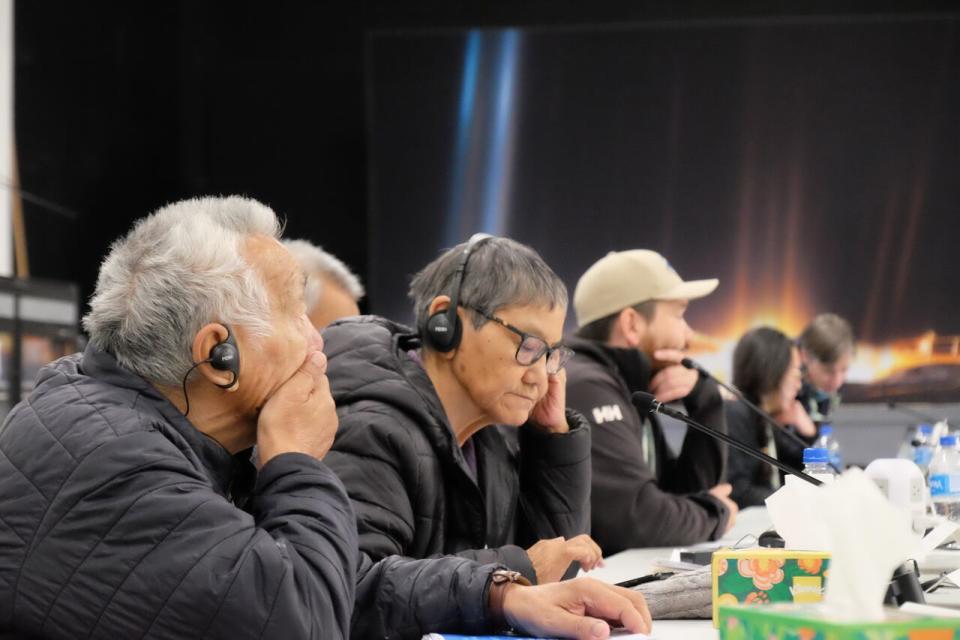 Eva Elytook, second from left, listens to interpretation during the hearing. Elytook is a representative from Baker Lake's hunters and trappers organization.