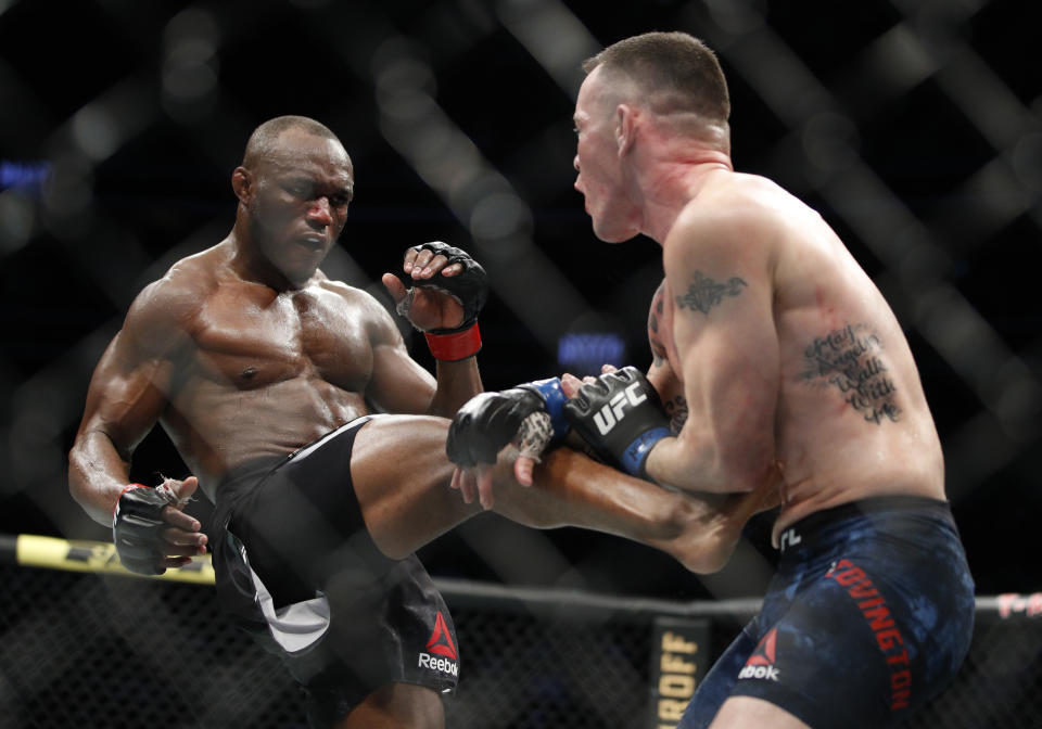 FILE - Kamaru Usman kicks Colby Covington in a mixed martial arts welterweight championship bout at UFC 245 in Las Vegas, in this Saturday, Dec. 14, 2019, file photo. UFC 261 is being touted as the first full-capacity sporting event held indoors in more than a year. The card features three title fights, highlighted by a rematch between reigning welterweight champion Kamaru “Nigerian Nightmare” Usman (18-1) and Jorge “King of Miami” Masvidal (35-14). (AP Photo/John Locher, File)