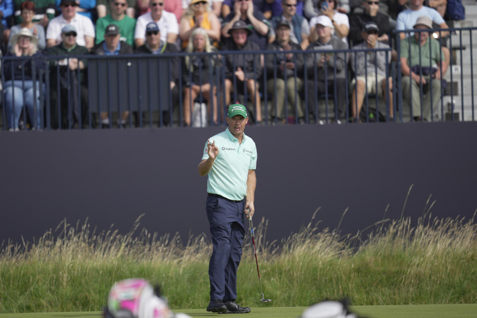 Ireland's Padraig Harrington acknowledges the crowd on the 3rd green on the first day of the British Open Golf Championships at the Royal Liverpool Golf Club in Hoylake, England, Thursday, July 20, 2023. (AP Photo/Kin Cheung)
