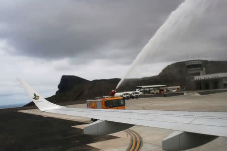 A fire truck sprays water over the first ever commercial flight to land at St Helena airport near Jamestown, October 14, 2017. Picture taken October 14, 2017. REUTERS/Ed Cropley